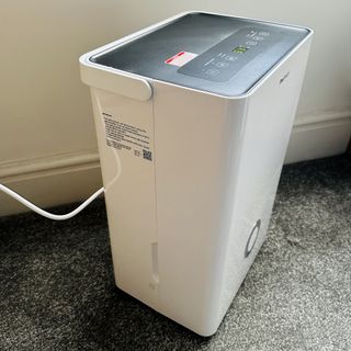 The Pro Breeze 30L High Capacity Smart Dehumidifier review being tested in a room with grey carpet