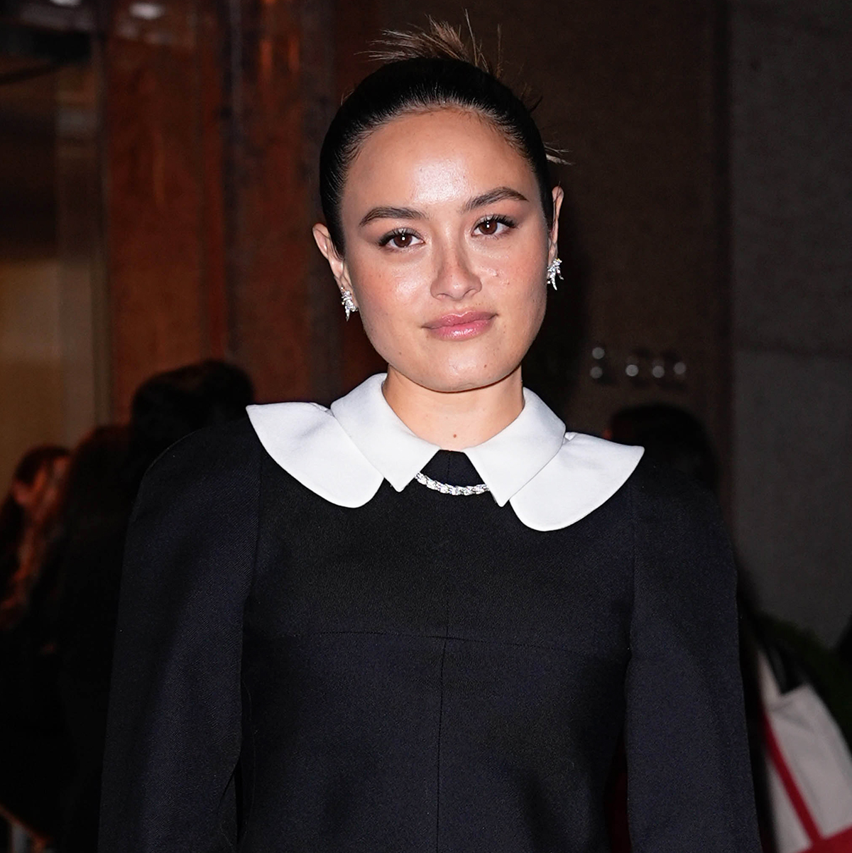 Chase Sui Wonders wearing a white-collar black jacket with a miniskirt