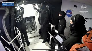 Ninja team stands around spacecraft hatch.