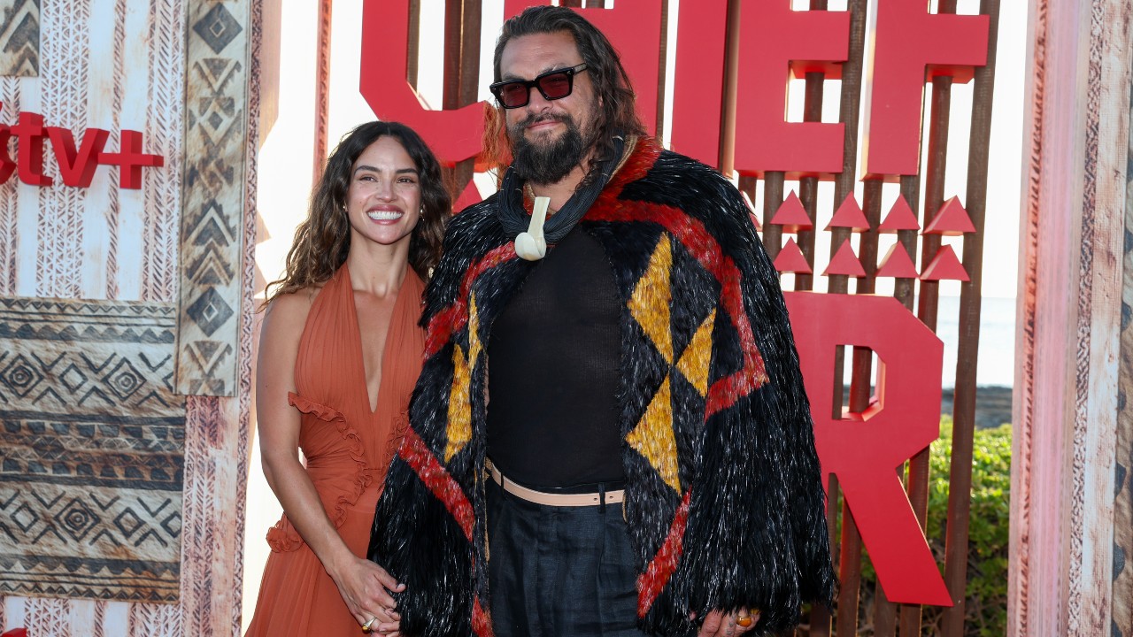 Adria Arjona and Jason Momoa holding hands at the world premiere of the Apple TV+ drama series &quot;Chief of War&quot; at Ko Olina Beach Park on July 18, 2025 in Kapolei, Hawaii.