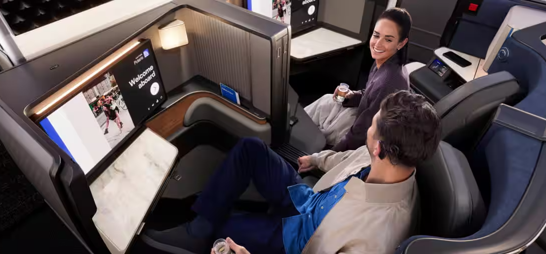 Man and woman seated in a Delta Polaris Business Class Suite