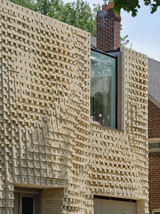 Canvas House exterior side view with rippling textured façade