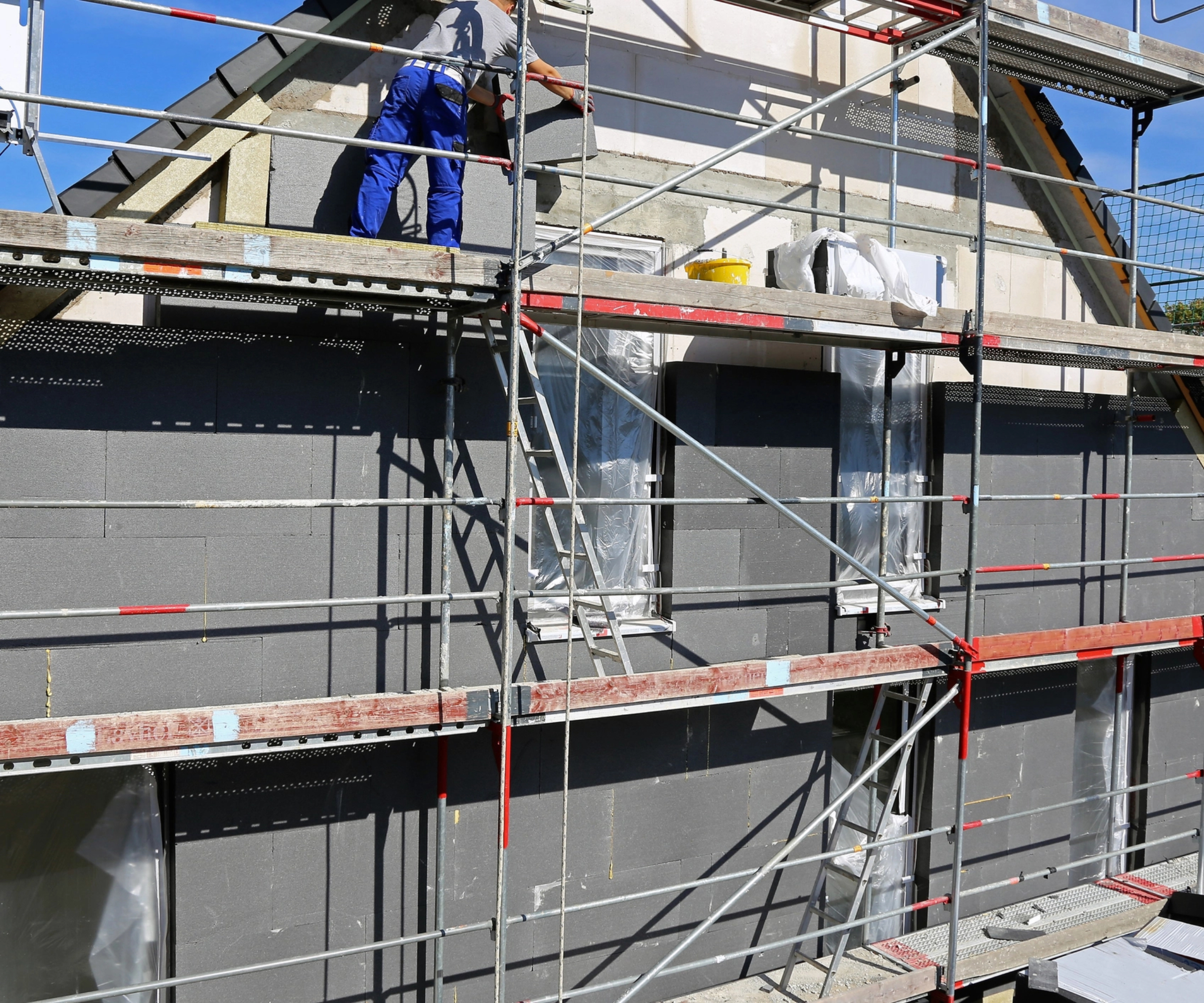 scaffolding on house while external wall insulation and cladding is added