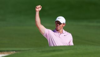 Rory McIlroy fist pumps after holing a bunker shot