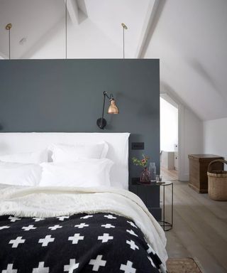 White bedroom with grey headboard and black and white throw