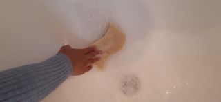 Scrubbing clean the bathtub