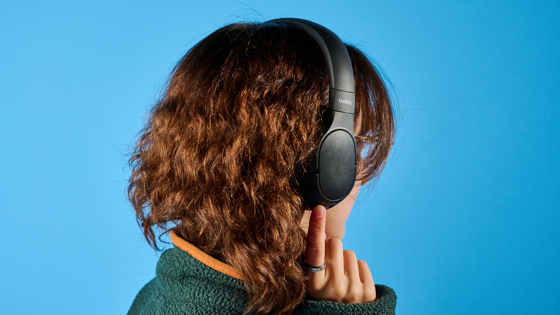 the belkin soundform isolate are a pair of budget headphones in black, with soft pillowy cups, control buttons on each cup, and ANC