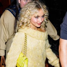 Sabrina Carpenter made a case for a butter yellow fall in an oversize sweater dress, a matching Chanel bag, and chunky socks