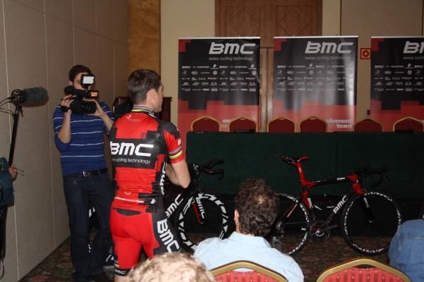 Where do I sit? Cadel Evans enters the building.