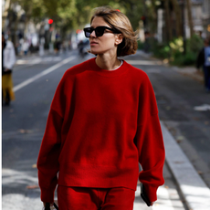 PARIS, FRANCE - OCTOBER 04: A guest wears red jumper, red trousers, brown Herm&egrave;s bag, outside Herm&egrave;s, during the Womenswear Spring Summer 2026 as part of Paris Fashion Week on October 04, 2025 in Paris, France. (Photo by Claudio Lavenia/Getty Images)