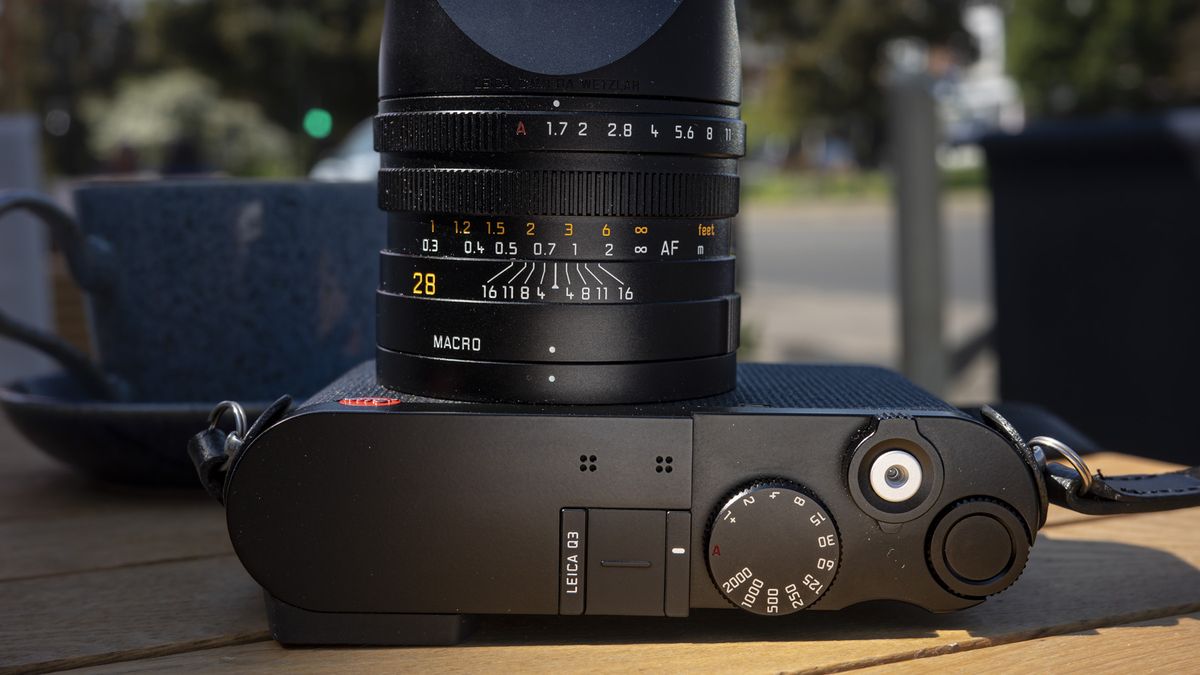 Leica Q3 camera on a wooden table view of camera top plate