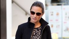 Pippa Middleton wearing black mini dress and practical coat with autumn-ready leather accessories