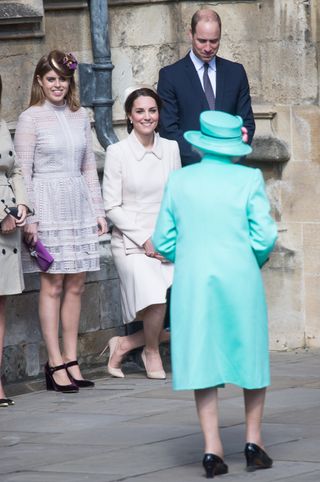 Catherine, Duchess of Cambridge performs a curtsy to Queen Elizabeth II as she attends Easter Day Service