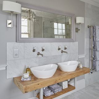 bathroom with mirror on wall and classic marble tiling