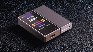 FiiO QX13 on a gray table