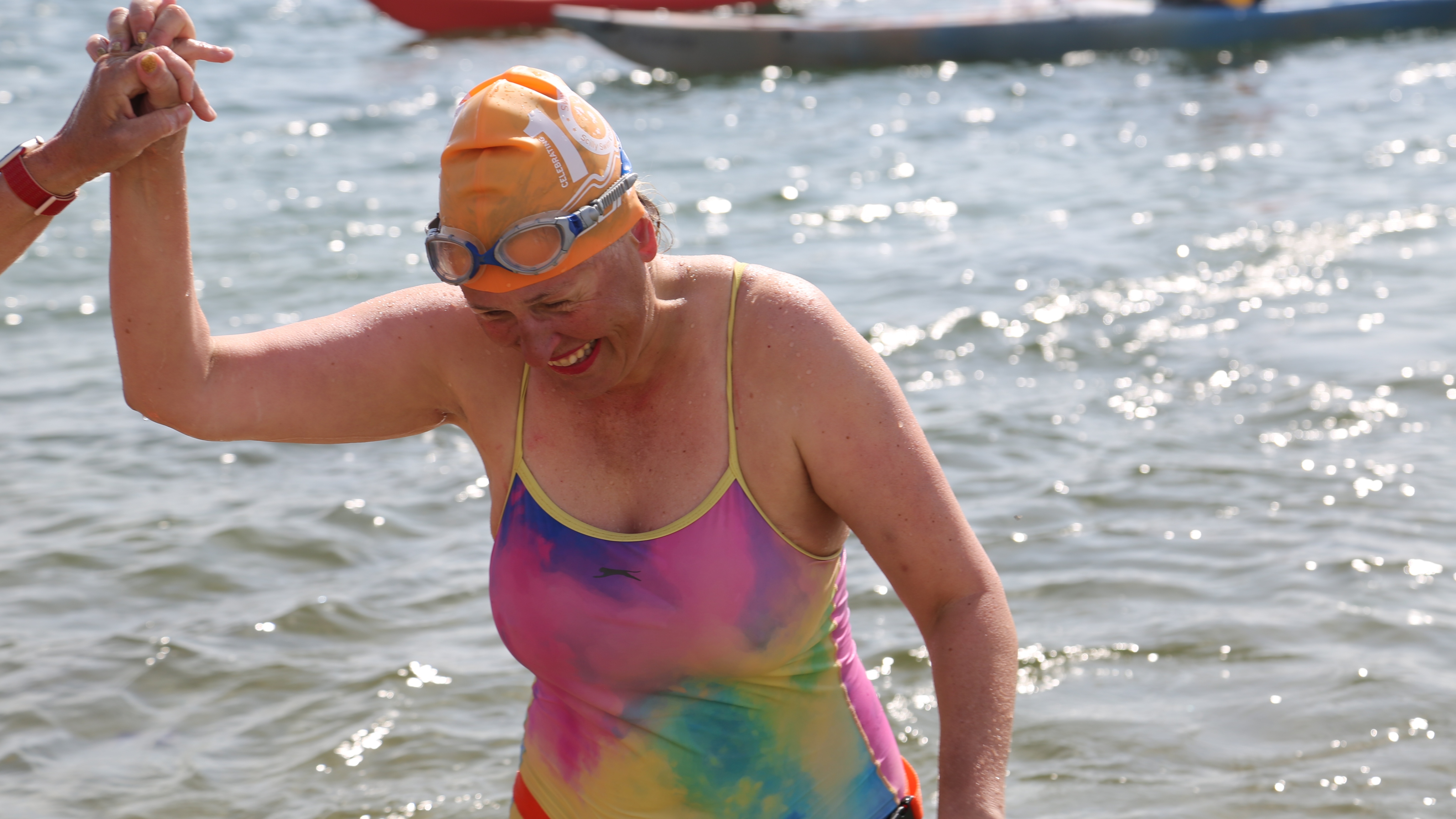 Jessica Hepburn smiling as she finishes an open water swim across the English Channel