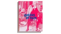 The very pink front cover of Queens of Pain, with a woman sat on a stool drinking coffee, a bicycle in the background