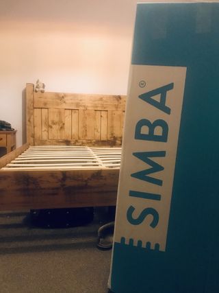 the Simba Hybrid Pro box in the bedroom with a wooden bed frame