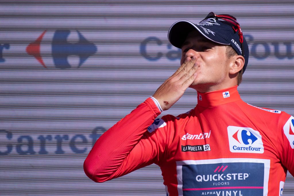 Team Quick Steps Belgian rider Remco Evenepoel celebrates on the podium wearing the overall leaders red jersey after the 15th stage of the 2022 La Vuelta cycling tour of Spain a 153 km race from Martos to the Alto Hoya de la Mora of the Sierra Nevada in Monachil on September 4 2022 Photo by JORGE GUERRERO AFP Photo by JORGE GUERREROAFP via Getty Images