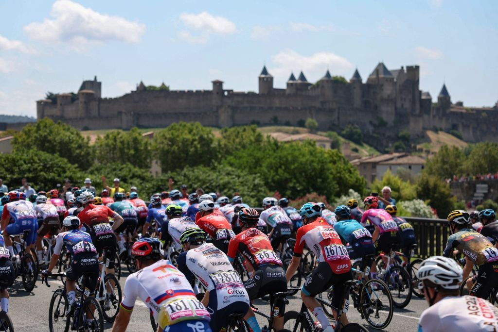 TOPSHOT The pack of riders cycles near the fortifications of Carassonne at the start of the 16th stage of the 109th edition of the Tour de France cycling race 1785 km between Carcassonne and Foix in southern France on July 19 2022 Photo by Thomas SAMSON AFP Photo by THOMAS SAMSONAFP via Getty Images