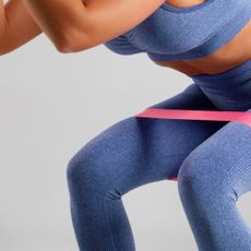 A woman doing one of the best resistance band workouts for beginners at home