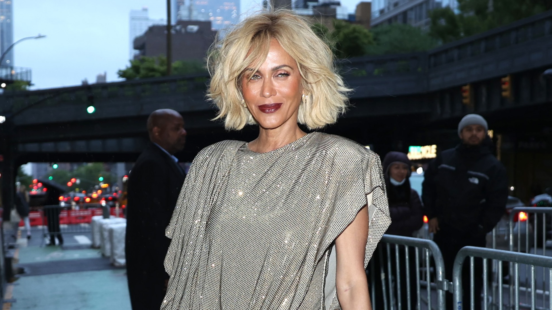 Nicole Ari Parker with a short blonde bob and dark purple lipstick