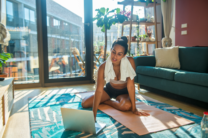 Woman working out in living room to avoid lockdown weight gain