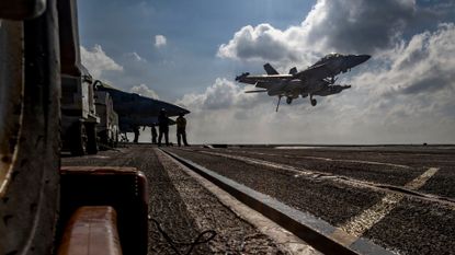 Fighter jet takes off from U.S. aircraft carrier Abraham Lincoln