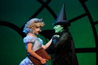 Performers Carly Anderson (L) plays the character 'Glinda' and Jacqueline Hughes (R) plays the character 'Elphaba' during the 'Wicked The Musical' media preview at the Grand Theatre, Marina Bay Sands on September 30, 2016 in Singapore