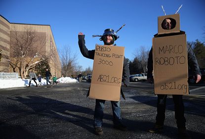Protesters dressed like robots mock Marco Rubio in New Hampshire