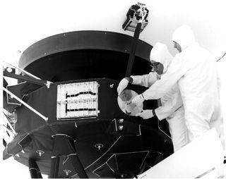 Engineers mount the Golden Record and secure its cover on Voyager 1.