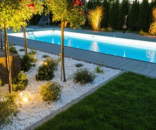 Scenic Residential Outdoor Swimming Pool Illuminated by LED Lighting.