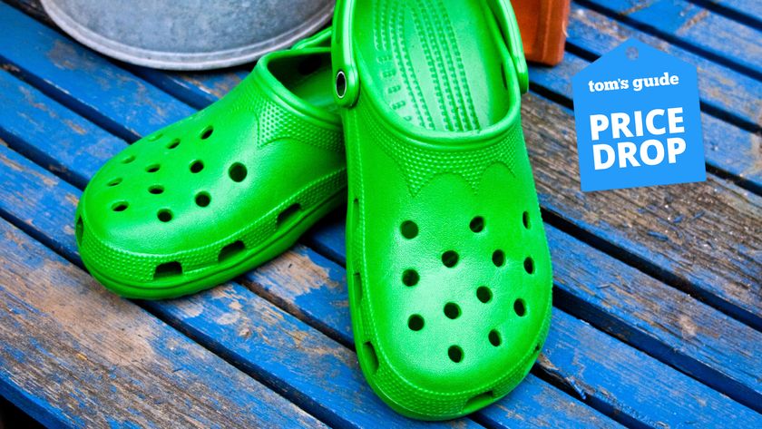 a pair of green Crocs on blue decking