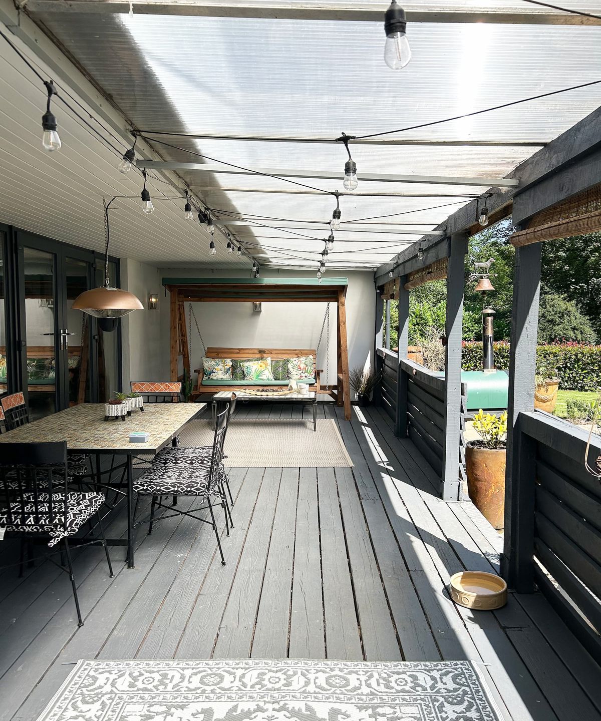 A grey porch attached to an extended bungalow