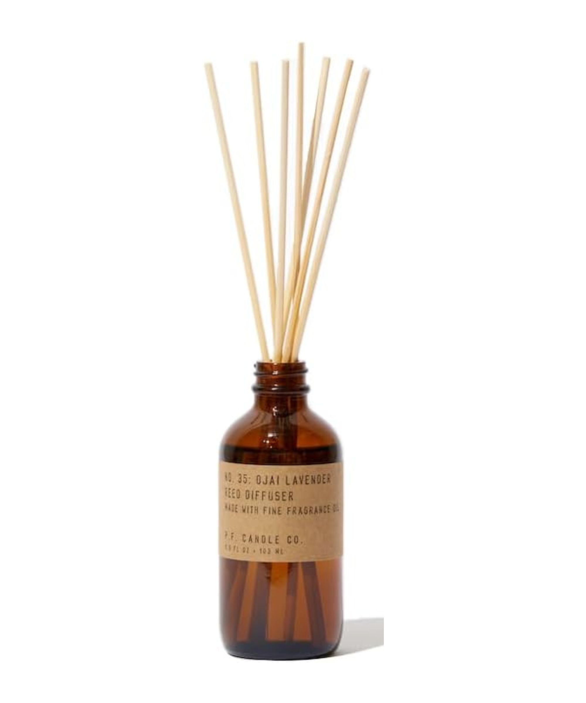 A reed diffuser with an amber glass bottle