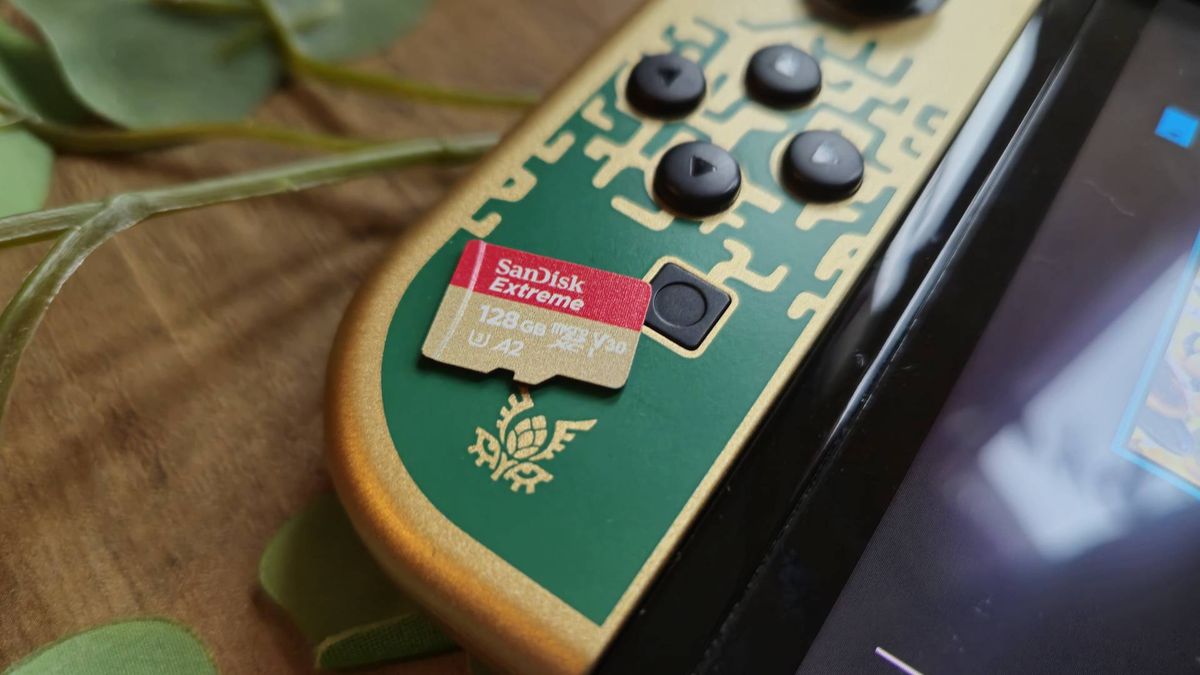 Photo of a 128GB microSD card sitting on a Tears of the Kingdom OLED Nintendo Switch.