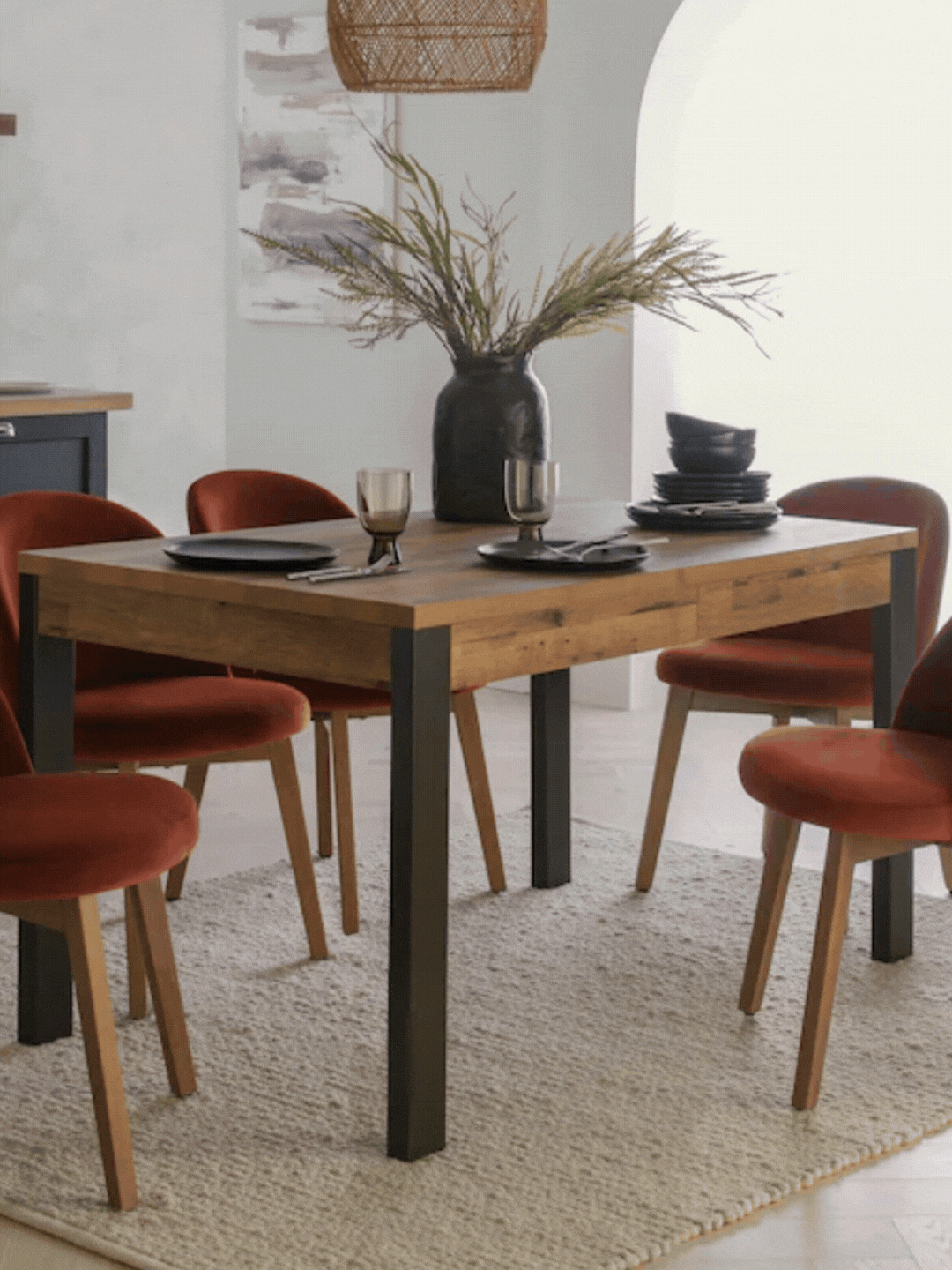 A GIF of a dark wooden dining table with storage