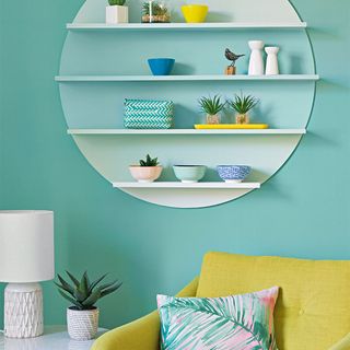 blue living room with circular wall shelf and yellow armchair
