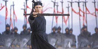 Hero Jet li stands in front of his army with a weapon in hand