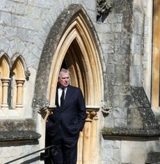 Prince Andrew standing in the archway of the chapel at Royal Lodge