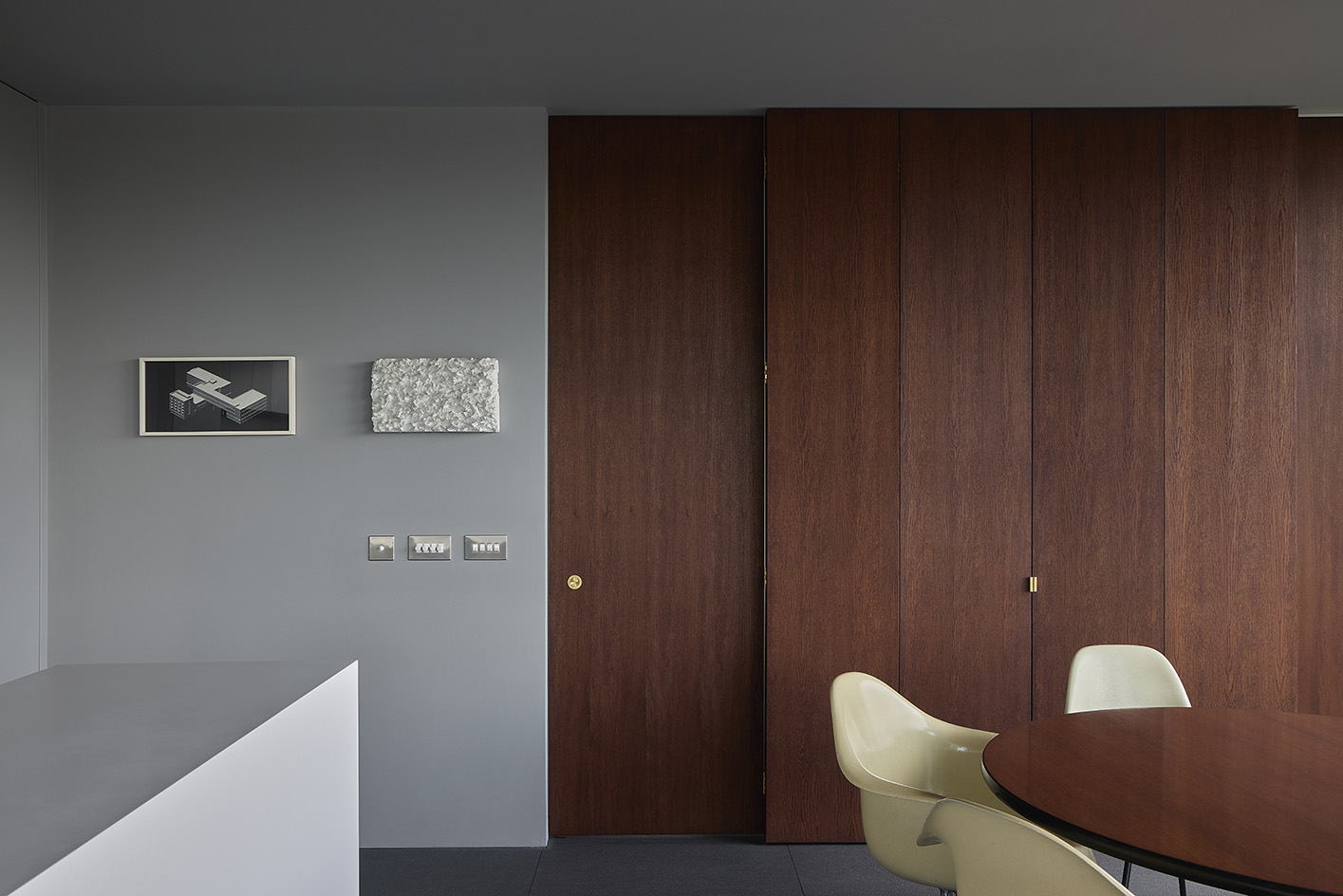 Clerkenwell Rooftop apartment in London, showing minimalist concrete and large openings with terrace and views out to urban views with green