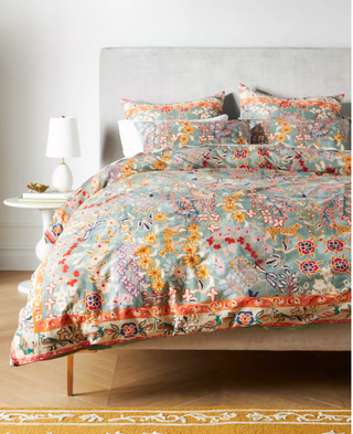 a colorful duvet set layed out on a bed