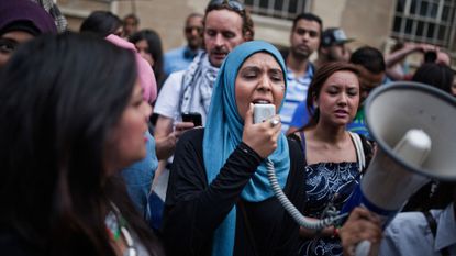 A woman speaks in megaphone at a London march, calling for a ceasefire between Israel and Palestine