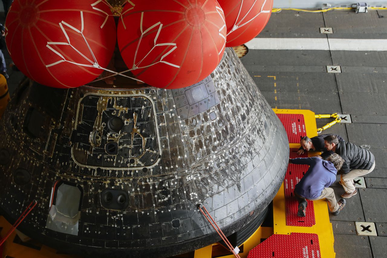Pictures of the Orion spacecraft being treated after arriving in port in San Diego on Dec. 13, 2022.