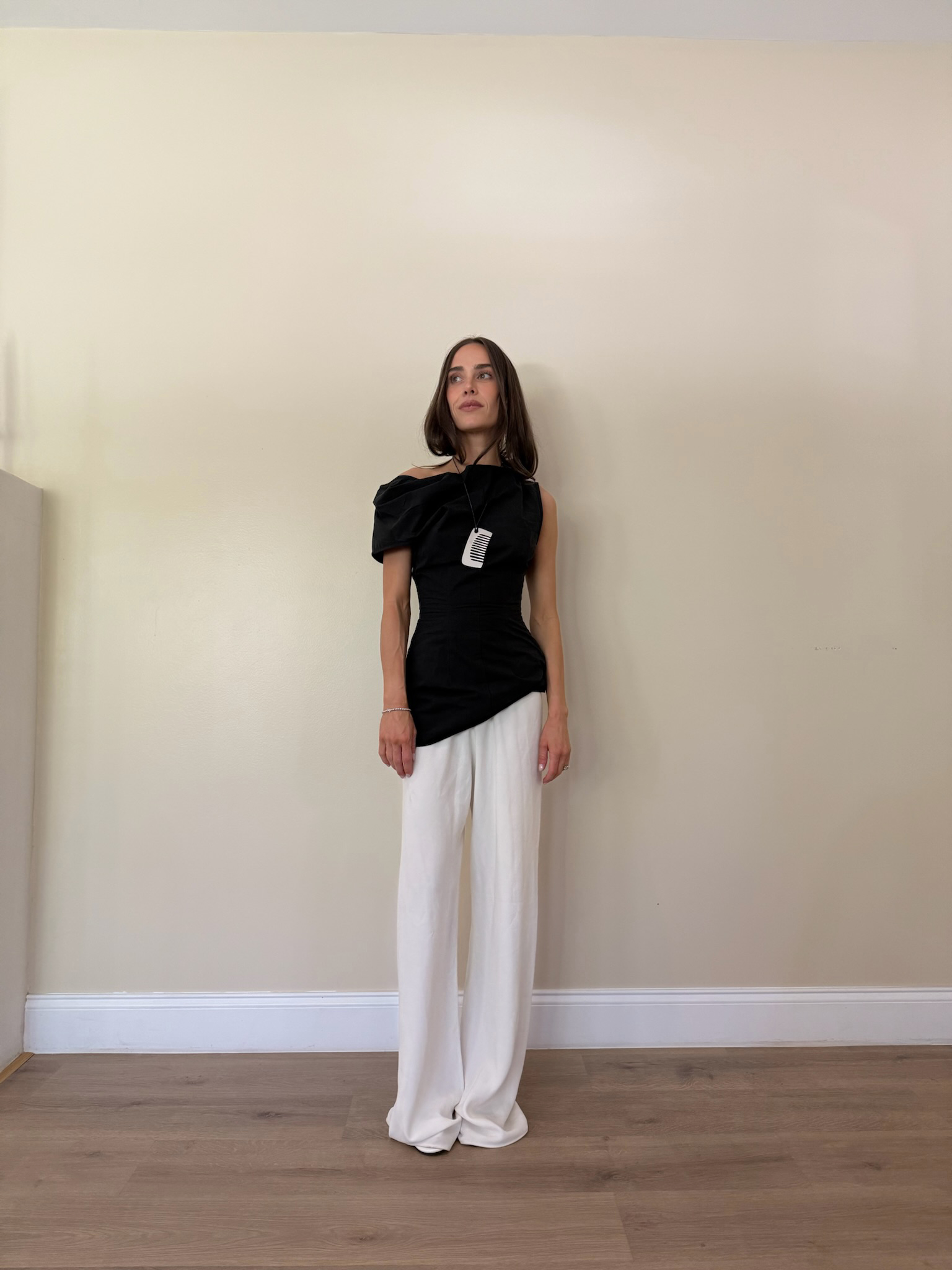 Kira Mackenzie Jackson wears flowy white pants and a structural black top