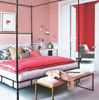 Red and white bedroom with four poster bed