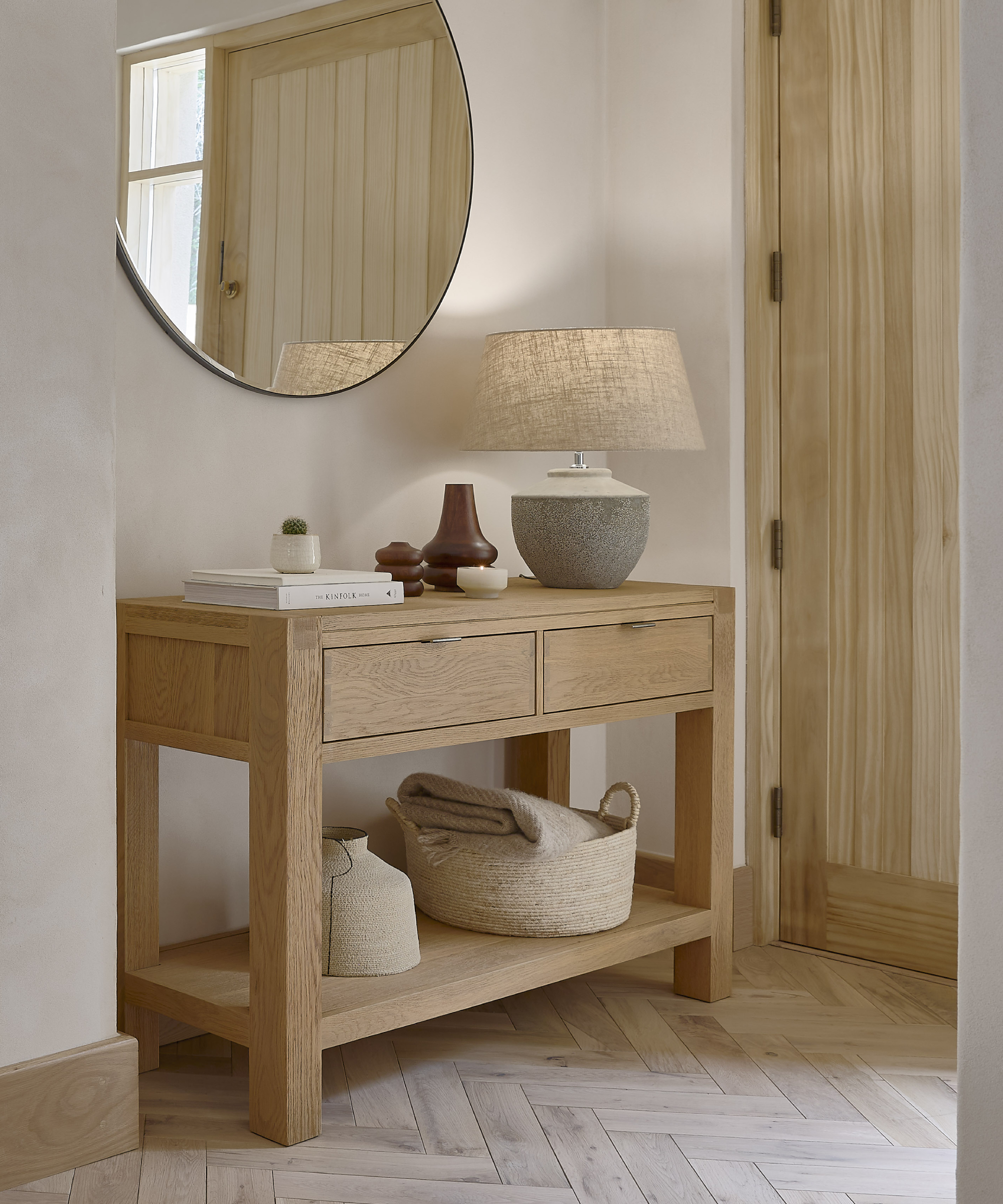 hallway with oak console table, table lamp, mirror and wooden floor