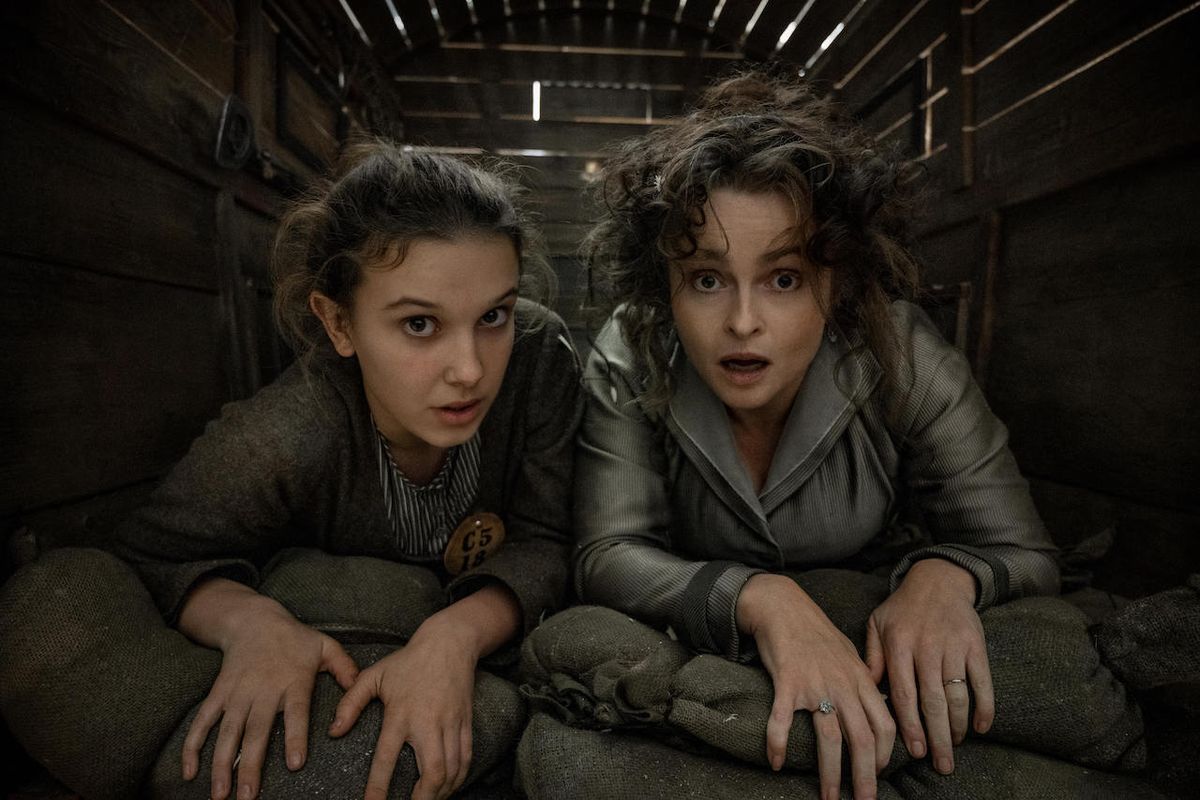 Millie Bobby Brown and Helena Bonham Carter closely cramped next to each other in Enola Holmes 2
