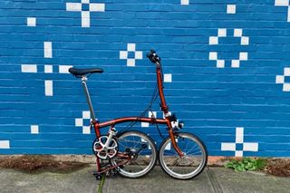 Rooks Brompton semi-folded up in front of a painted wall mural