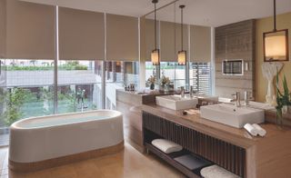 Spacious bathroom with tub and large windows